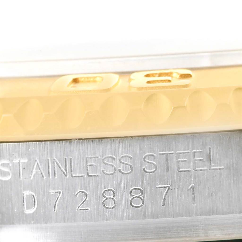 This close-up image shows the side view of a Rolex Yacht-Master 16623 Men's Stainless Steel Champagne Dial 16623 Men's Stainless Steel Champagne Dial's bezel and case with engraved serial number.