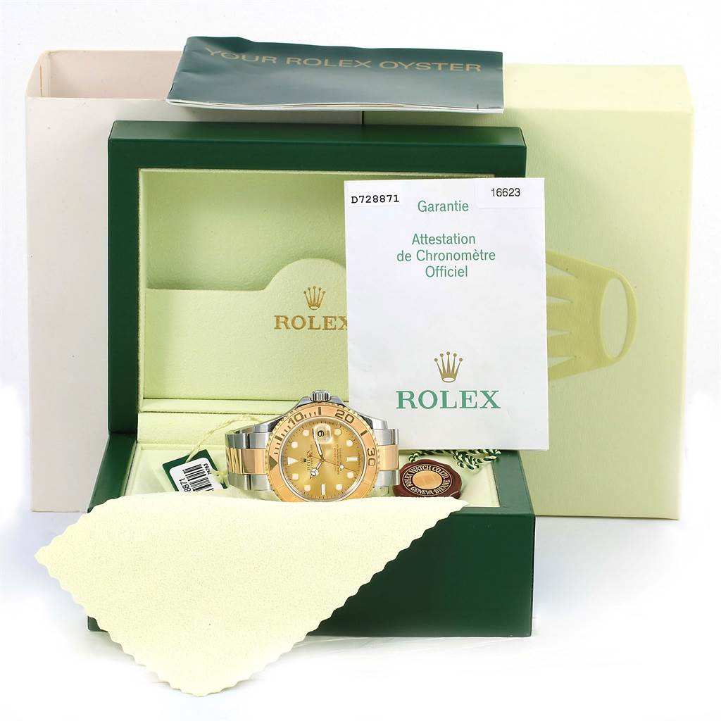 The image shows a Rolex Yacht-Master 16623 Men's Stainless Steel Champagne Dial 16623 Men's Stainless Steel Champagne Dial watch in its box, alongside its warranty, instruction booklet, and a cleaning cloth.