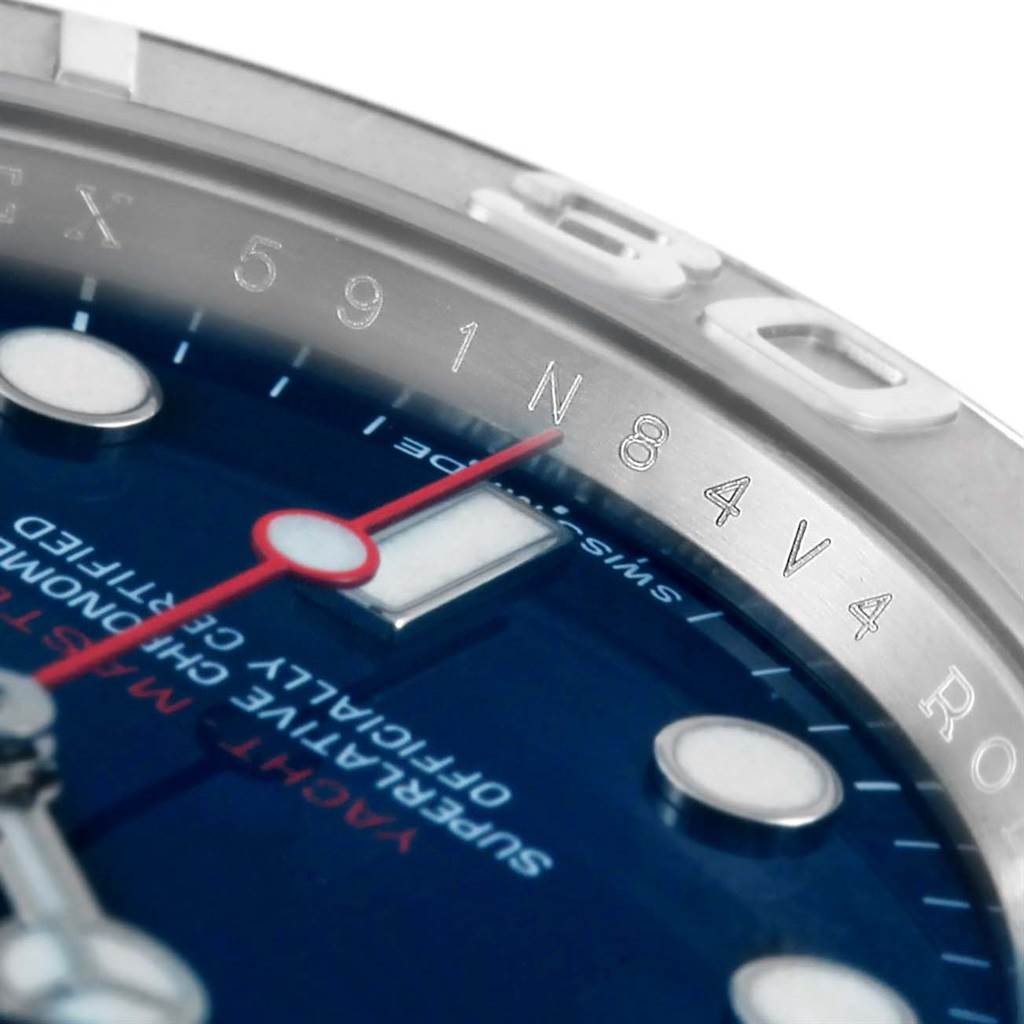This close-up angle of the Rolex Yacht-Master 116622 Men's Stainless Steel Blue Dial 116622 Men's Stainless Steel Blue Dial watch shows part of the dial, hands, and the engraved bezel.
