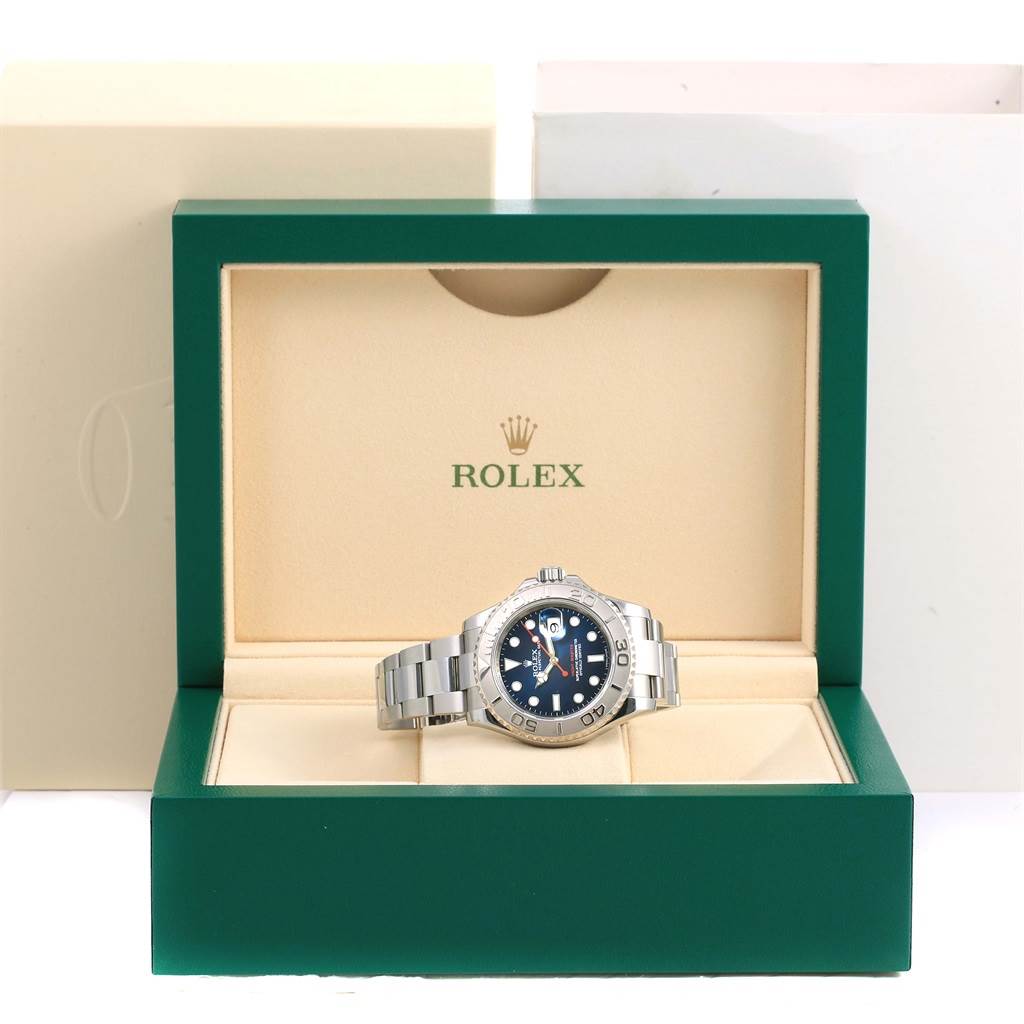 The Rolex Yacht-Master 116622 Men's Stainless Steel Blue Dial 116622 Men's Stainless Steel Blue Dial watch is shown front-facing inside a green and beige Rolex box.