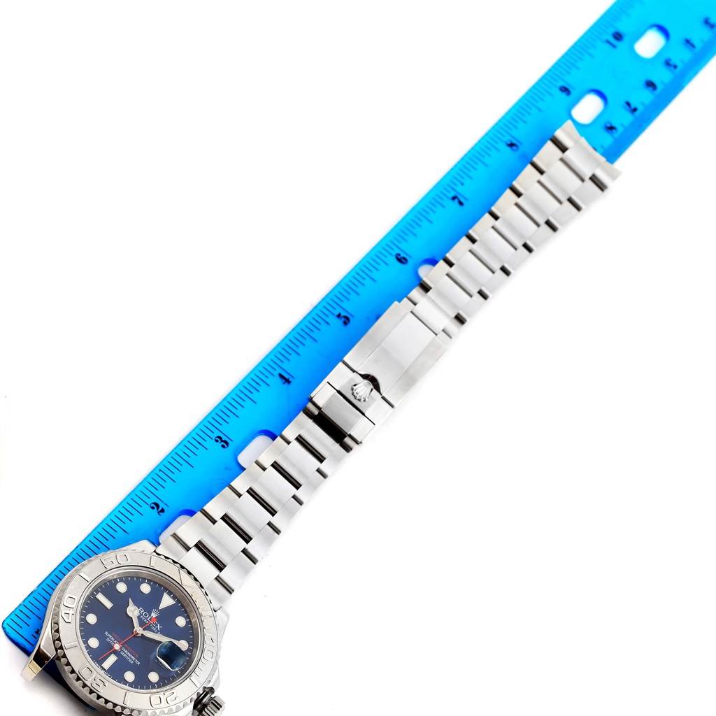 The image shows a Rolex Yacht-Master 116622 Men's Stainless Steel Blue Dial 116622 Men's Stainless Steel Blue Dial watch laid next to a blue ruler, displaying the watch face and strap.