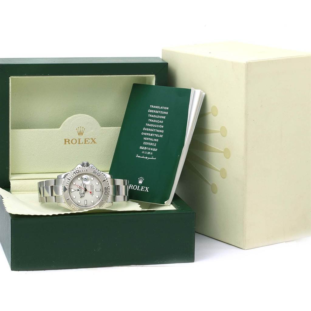 The Rolex Yacht-Master 16622 Men
s Stainless Steel Silver Dial 16622 Men
s Stainless Steel Silver Dial watch is shown from the front inside its opened box, alongside its manual.