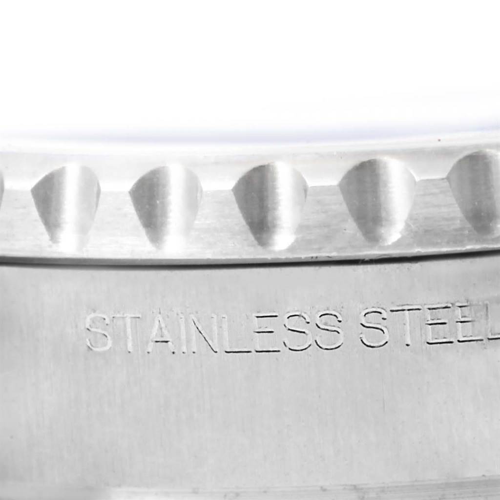 The image shows a close-up of the bezel and part of the case back of the Rolex Yacht-Master 116680 Men's Stainless Steel White Dial 116680 Men's Stainless Steel White Dial watch, with "STAINLESS STEEL" engraved.