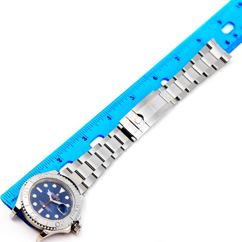 This image shows a side angle of a Rolex Yacht-Master 116622 Men's Stainless Steel Blue Dial 116622 Men's Stainless Steel Blue Dial watch, displaying the bracelet and clasp against a ruler for scale.