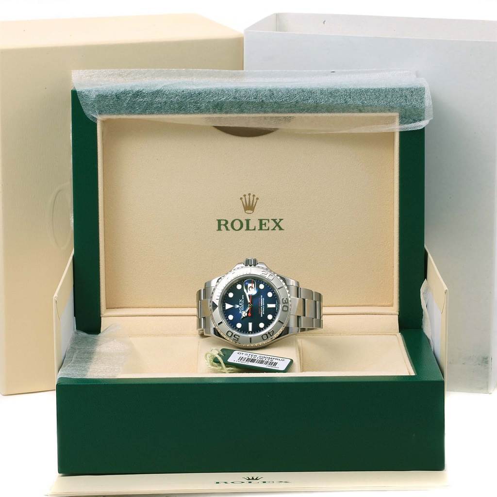 The Rolex Yacht-Master 116622 Men's Stainless Steel Blue Dial 116622 Men's Stainless Steel Blue Dial watch is displayed front-facing inside an open green and beige box.