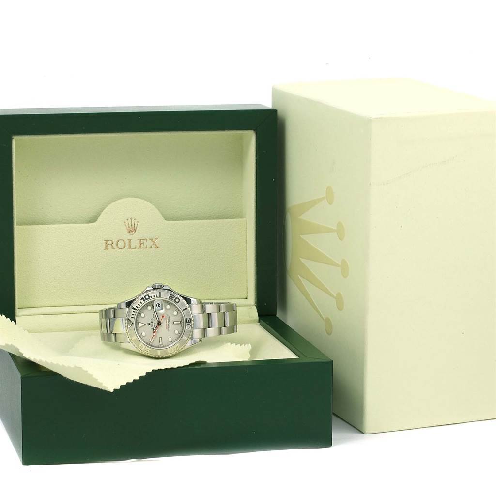 The Rolex Yacht-Master 168622 Stainless Steel Silver Dial 168622 Stainless Steel Silver Dial watch is shown front-facing in its open green and beige box, with the outer box nearby.