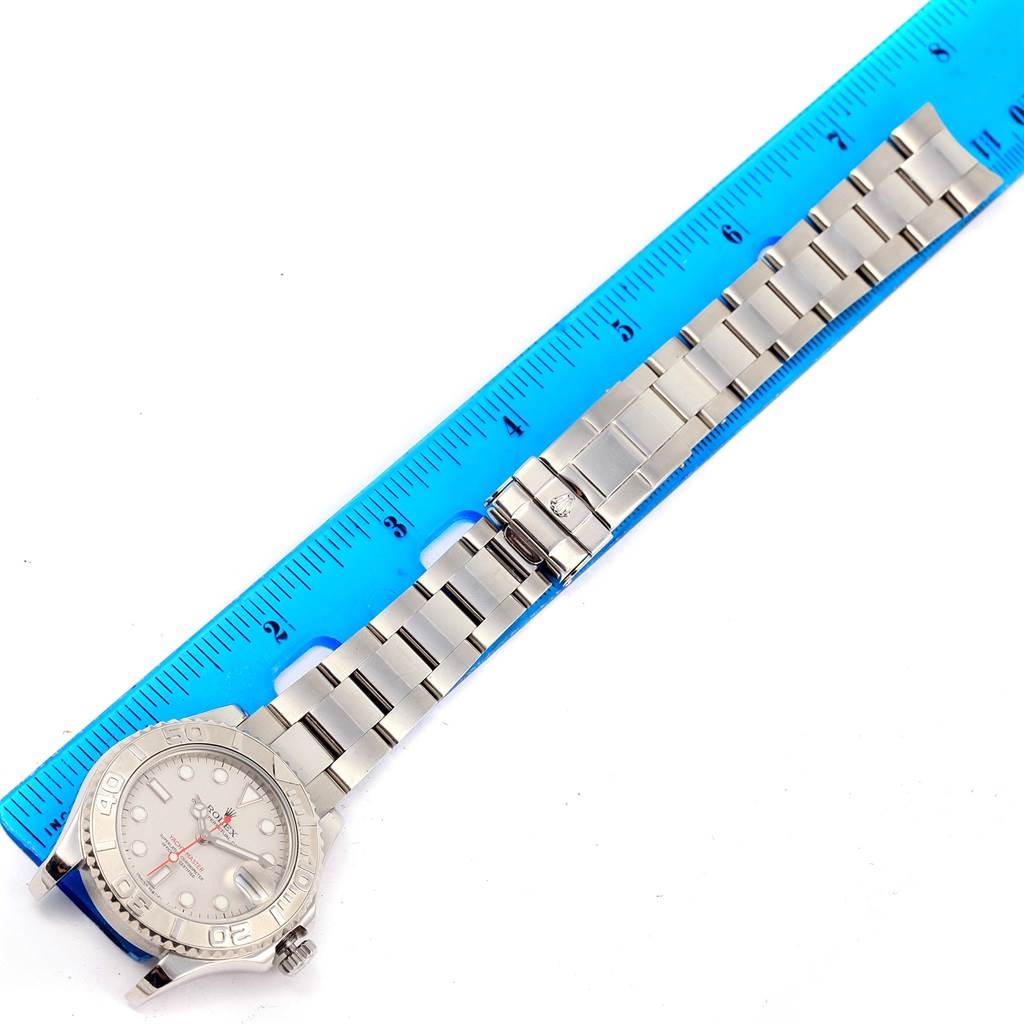 The image shows the entire Rolex Yacht-Master 168622 Stainless Steel Silver Dial 168622 Stainless Steel Silver Dial watch, with its bracelet fully extended next to a blue ruler for size reference.