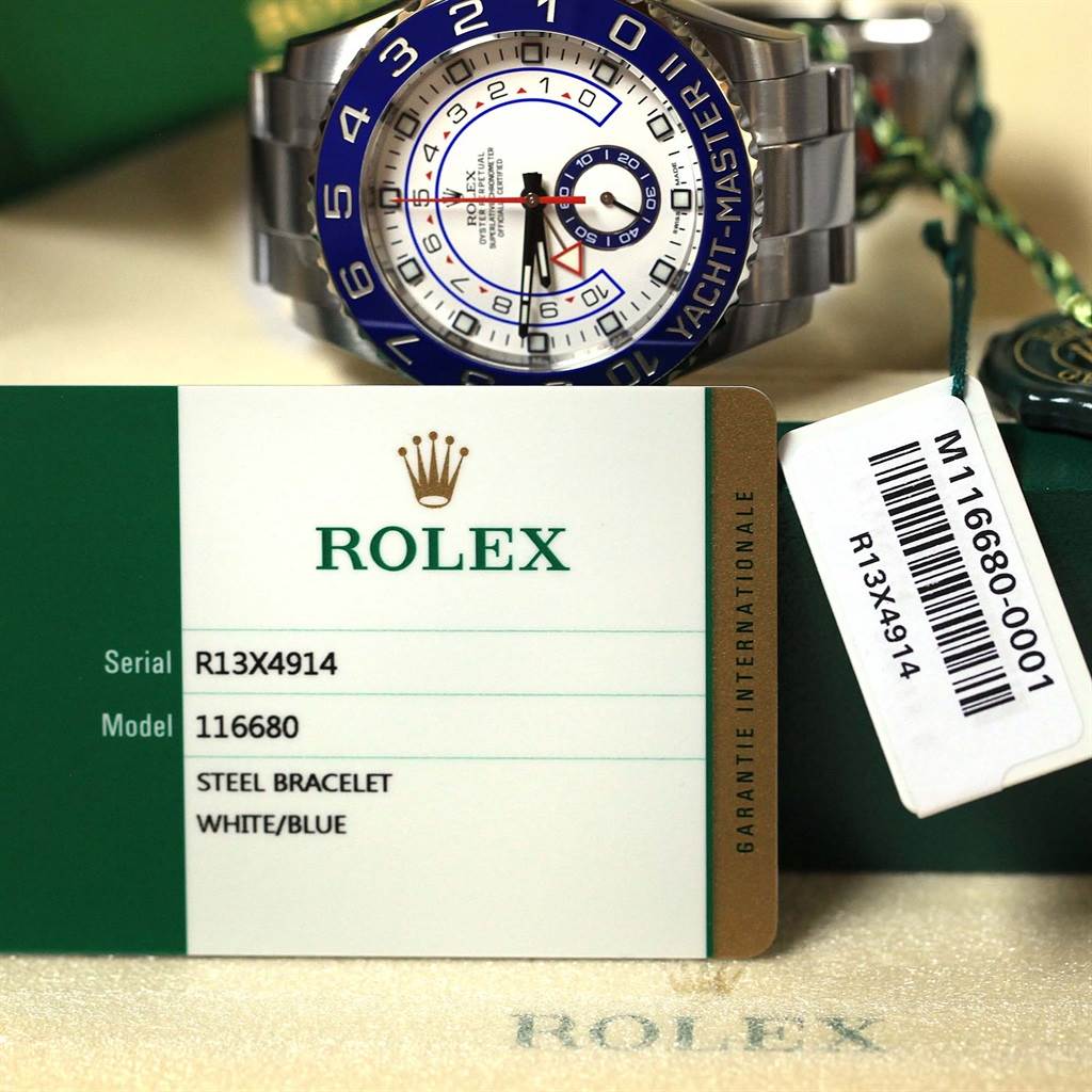 The image shows a Rolex Yacht-Master 116680 Men's Stainless Steel White Dial 116680 Men's Stainless Steel White Dial watch face and bracelet, alongside its warranty card and tags.