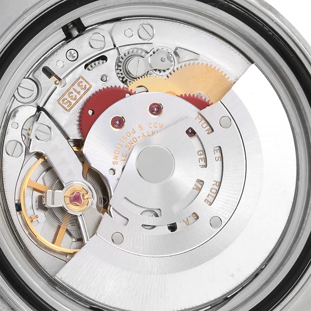 The image shows the movement mechanism of a Rolex Yacht-Master 16622 Men's Stainless Steel Silver Dial 16622 Men's Stainless Steel Silver Dial watch, featuring gears, springs, and the rotor.
