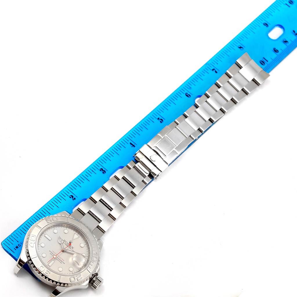 The image shows a Rolex Yacht-Master 16622 Men's Stainless Steel Silver Dial 16622 Men's Stainless Steel Silver Dial watch laid flat with the face, bezel, bracelet, and clasp visible next to a blue ruler.