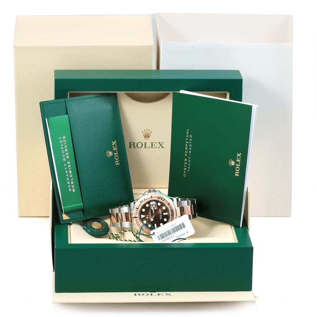 The image displays a Rolex Yacht-Master 116621 Men's Stainless Steel Brown Dial 116621 Men's Stainless Steel Brown Dial watch, its packaging, warranty booklet, and other accessories from a front angle.