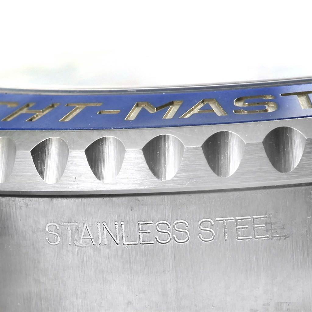 This close-up angle of the Rolex Yacht-Master 116680 Men's Stainless Steel White Dial 116680 Men's Stainless Steel White Dial watch shows the bezel and part of the stainless steel casing.