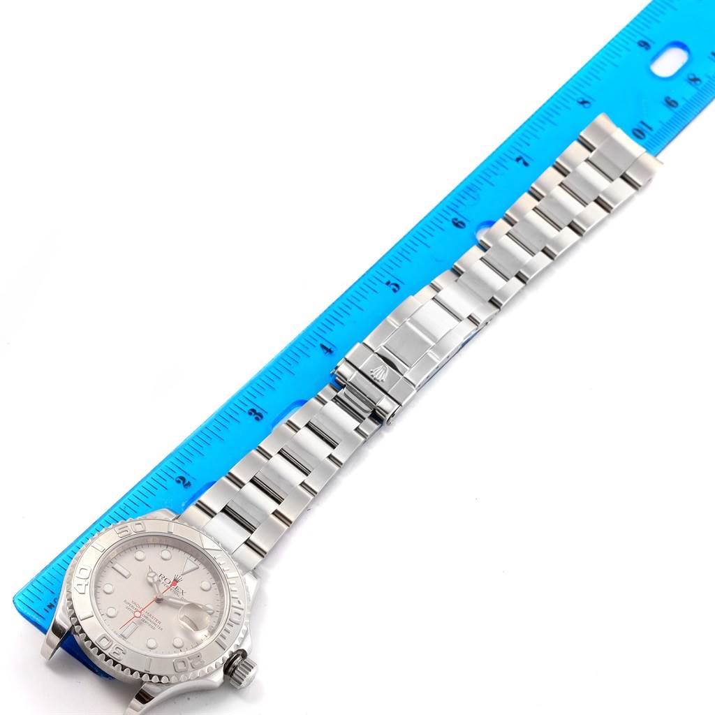 The Rolex Yacht-Master 16622 Men's Stainless Steel Silver Dial 16622 Men's Stainless Steel Silver Dial watch is shown from a top-down angle, highlighting the face, bezel, and bracelet against a ruler.