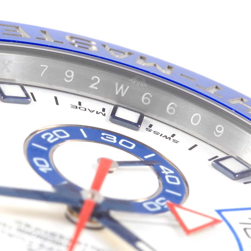 The image shows a close-up of the Rolex Yacht-Master 116680 Men's Stainless Steel White Dial 116680 Men's Stainless Steel White Dial watch dial, including part of the bezel with numerical markings and the minute hand.