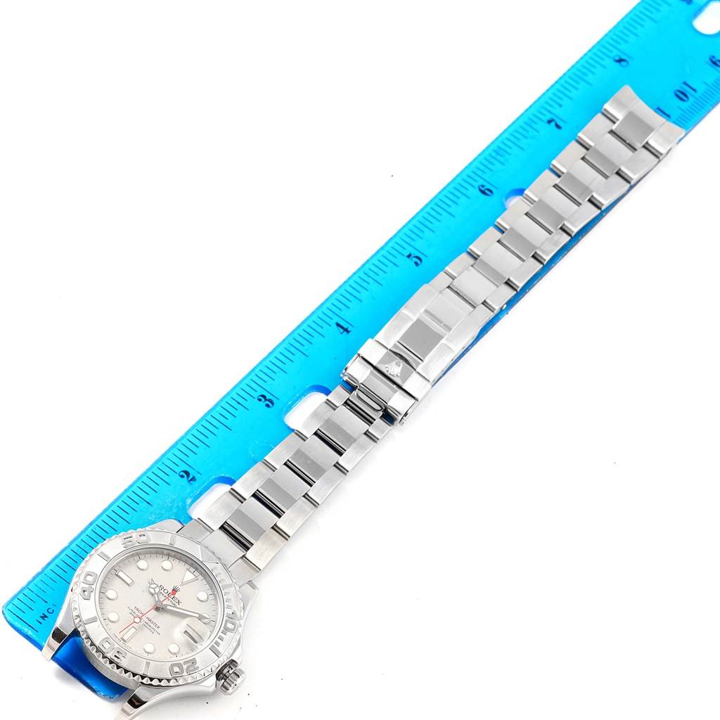 The Rolex Yacht-Master 168622 Men's Stainless Steel Silver Dial 168622 Men's Stainless Steel Silver Dial watch is shown from a top-down angle, displaying the bracelet, clasp, and dial alongside a measuring scale.