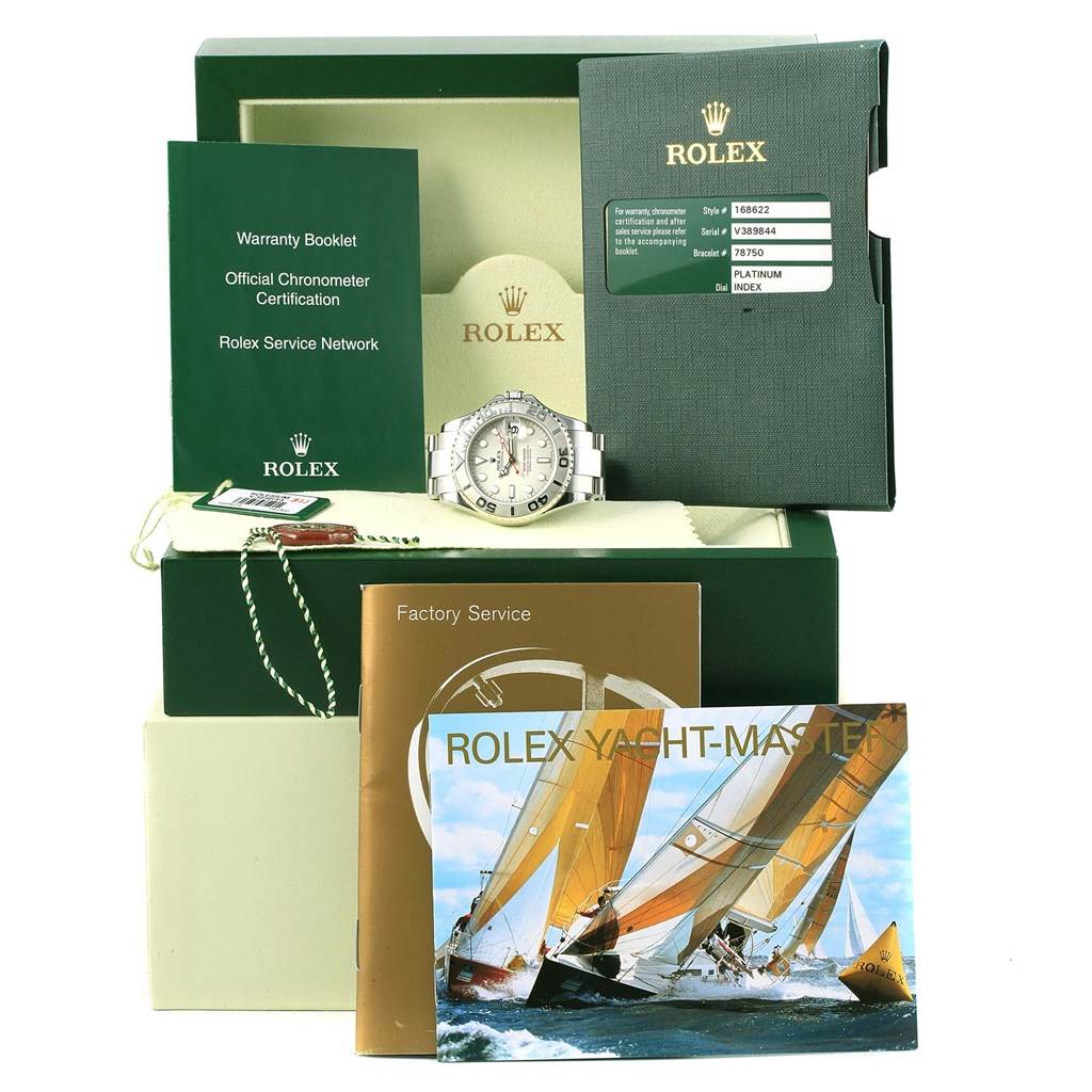 The image shows a Rolex Yacht-Master 168622 Men's Stainless Steel Silver Dial 168622 Men's Stainless Steel Silver Dial watch and accessories from a front angle, including its box, warranty booklets, and tags.