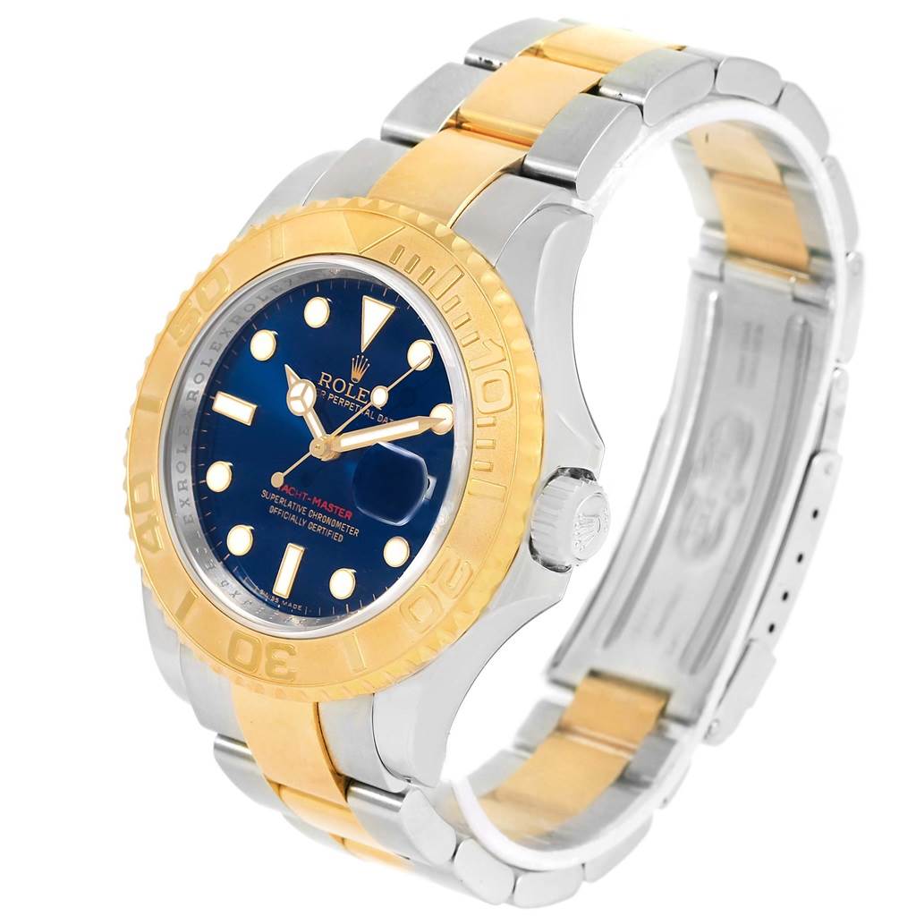 This image shows the Yacht-Master model by Rolex from an angled side view, highlighting its blue dial, gold bezel, and two-tone bracelet.