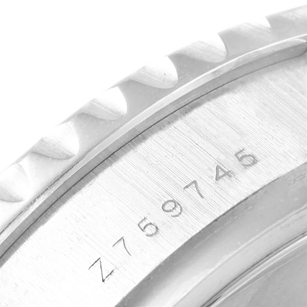 The image shows a close-up of the bezel and engraved serial number of a Rolex Yacht-Master 116689 Men's White Gold White Dial 116689 Men's White Gold White Dial watch.