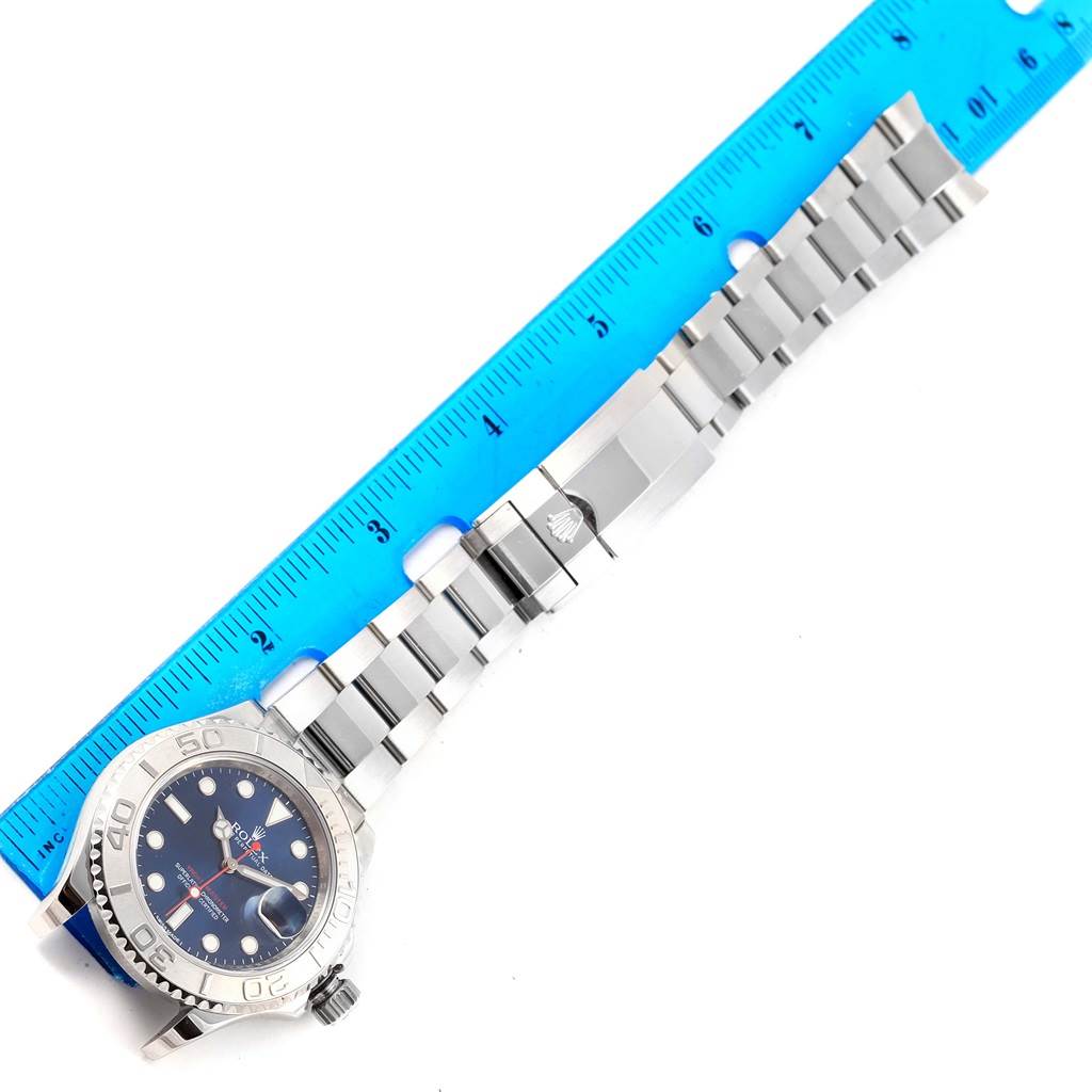 The image shows a Rolex Yacht-Master 116622 Men's Stainless Steel Blue Dial 116622 Men's Stainless Steel Blue Dial watch laid flat with a blue ruler measuring its length.