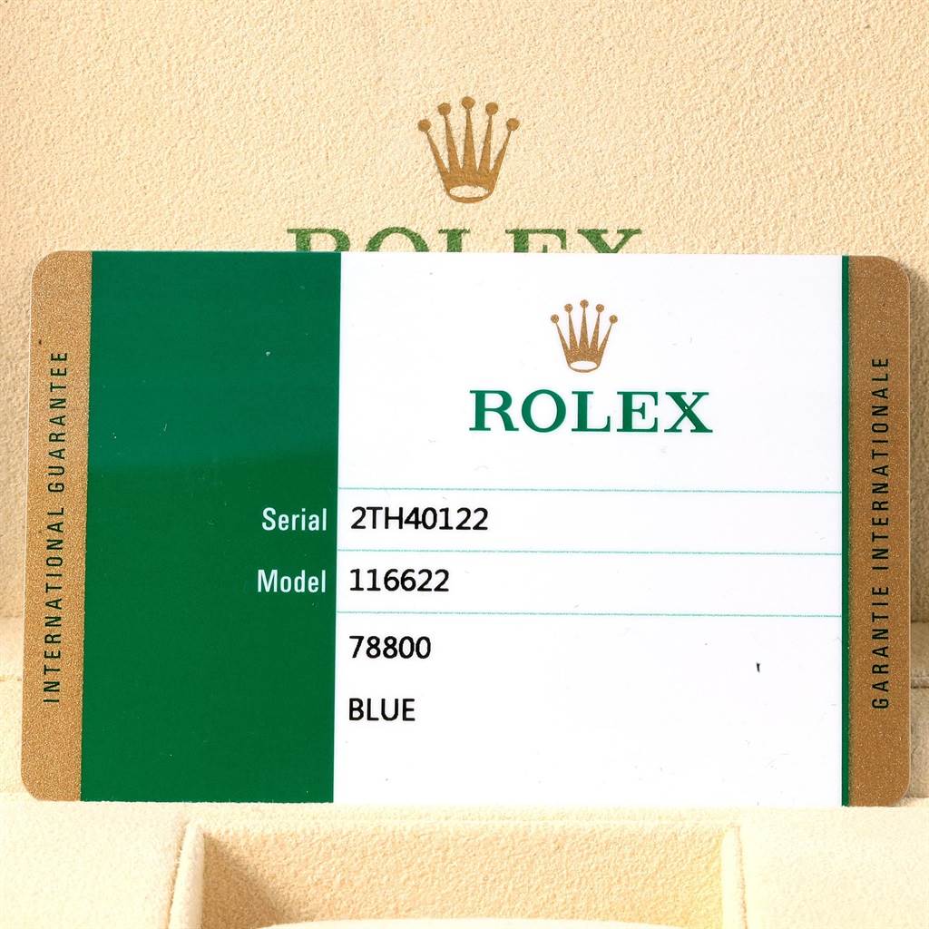 The image shows a warranty card for the Rolex Yacht-Master 116622 Men's Stainless Steel Blue Dial 116622 Men's Stainless Steel Blue Dial model, placed inside a watch box.