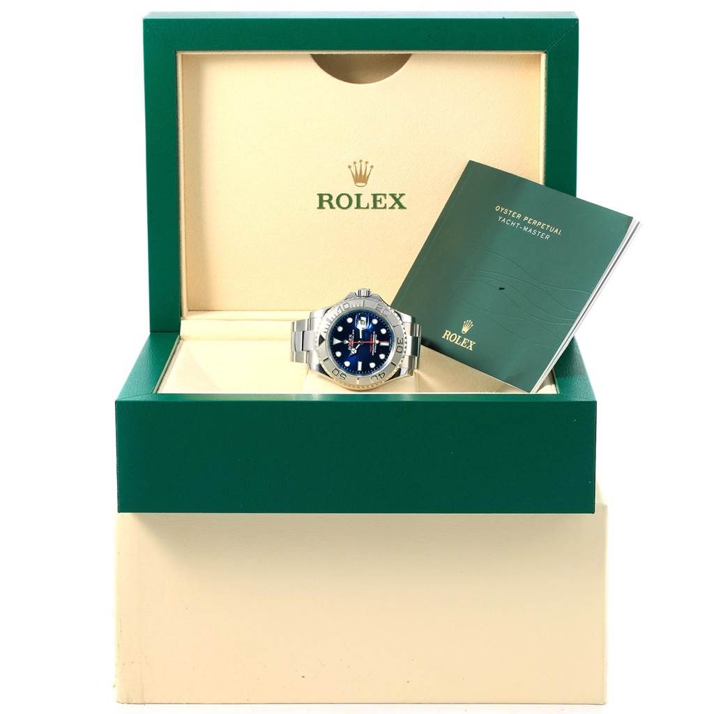 The Rolex Yacht-Master 116622 Men's Stainless Steel Blue Dial 116622 Men's Stainless Steel Blue Dial watch is displayed front-facing in an open box with its manual beside it.
