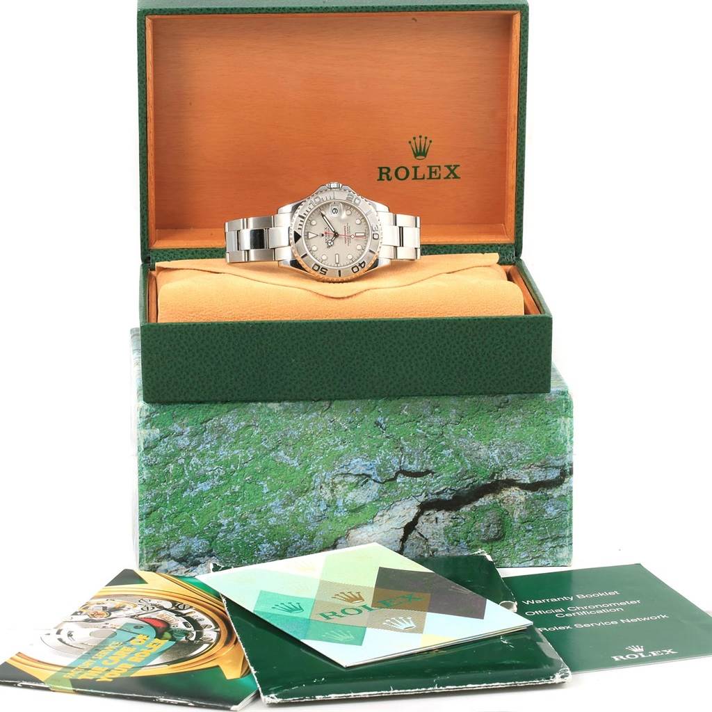 The Rolex Yacht-Master 168622 Men's Stainless Steel Silver Dial 168622 Men's Stainless Steel Silver Dial watch is displayed front-facing in its box with booklets and warranty papers in front.