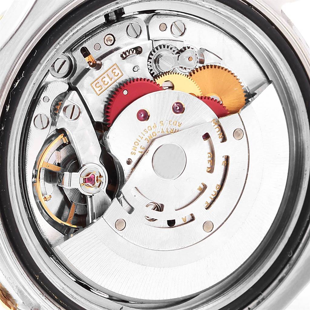 The image shows a close-up of the internal mechanics of a Rolex Yacht-Master 16623 Men's Stainless Steel Blue Dial 16623 Men's Stainless Steel Blue Dial watch, highlighting gears and movement components.
