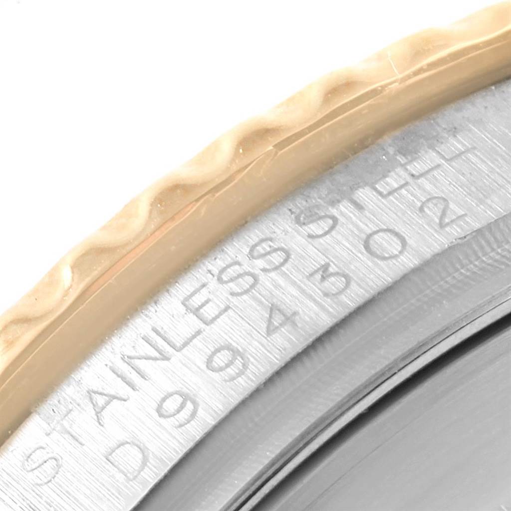 This image shows a close-up of the engraved stainless steel case and ridged bezel of a Rolex Yacht-Master 16623 Men's Stainless Steel Blue Dial 16623 Men's Stainless Steel Blue Dial watch.