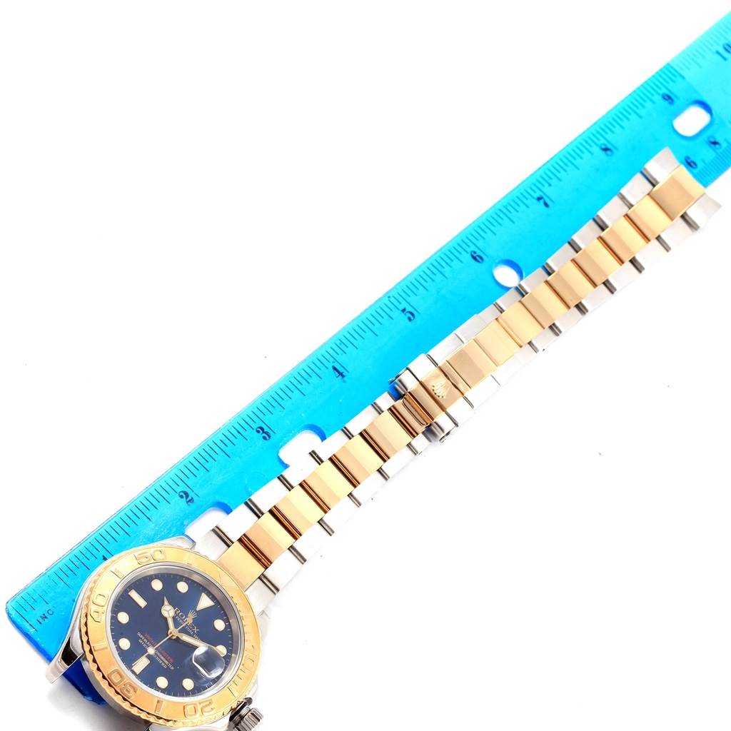 This image shows the front view of a Rolex Yacht-Master 16623 Men's Stainless Steel Blue Dial 16623 Men's Stainless Steel Blue Dial watch, highlighting its face, bezel, and bracelet with a ruler for scale.