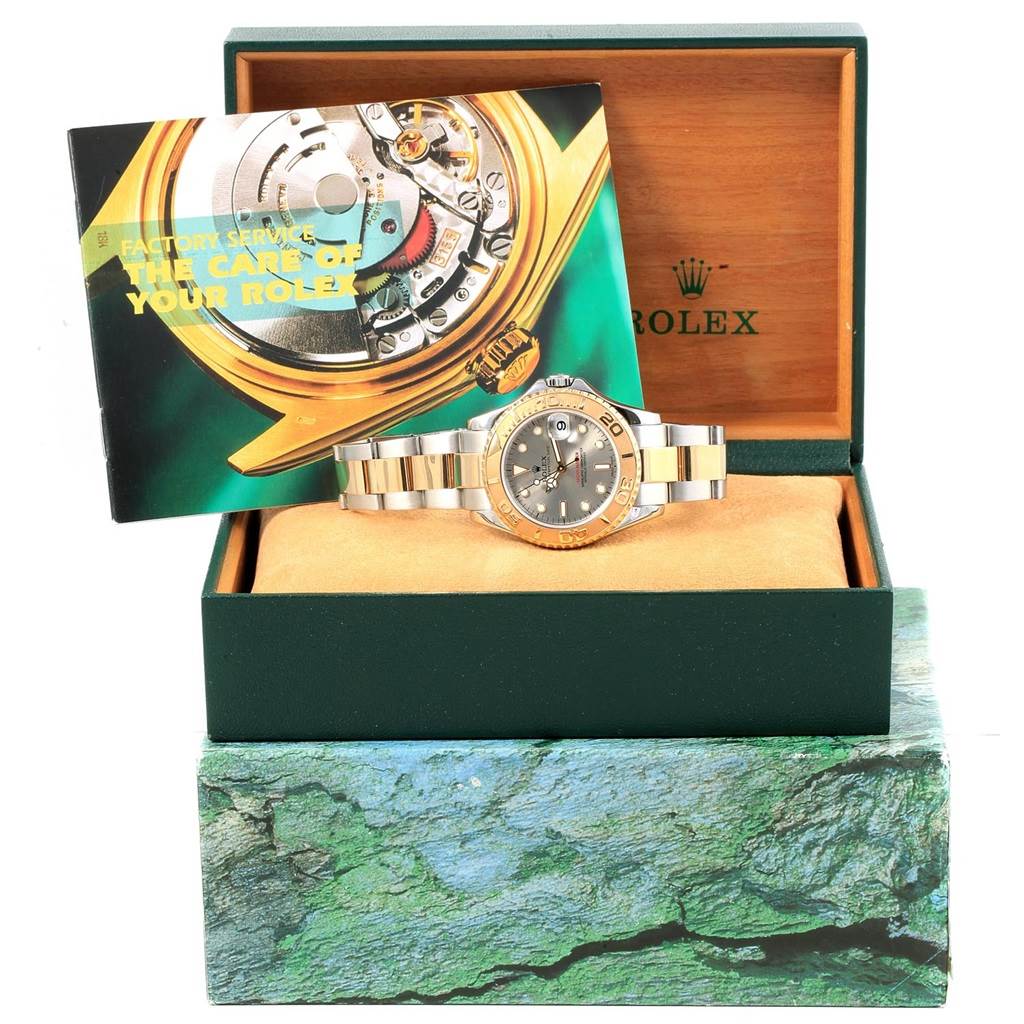 The Rolex Yacht-Master 168623 Men's Steel and Gold (two tone) Grey Dial 168623 Men's Steel and Gold (two tone) Grey Dial watch is shown from the front, displayed inside its original box with a care booklet resting behind it.