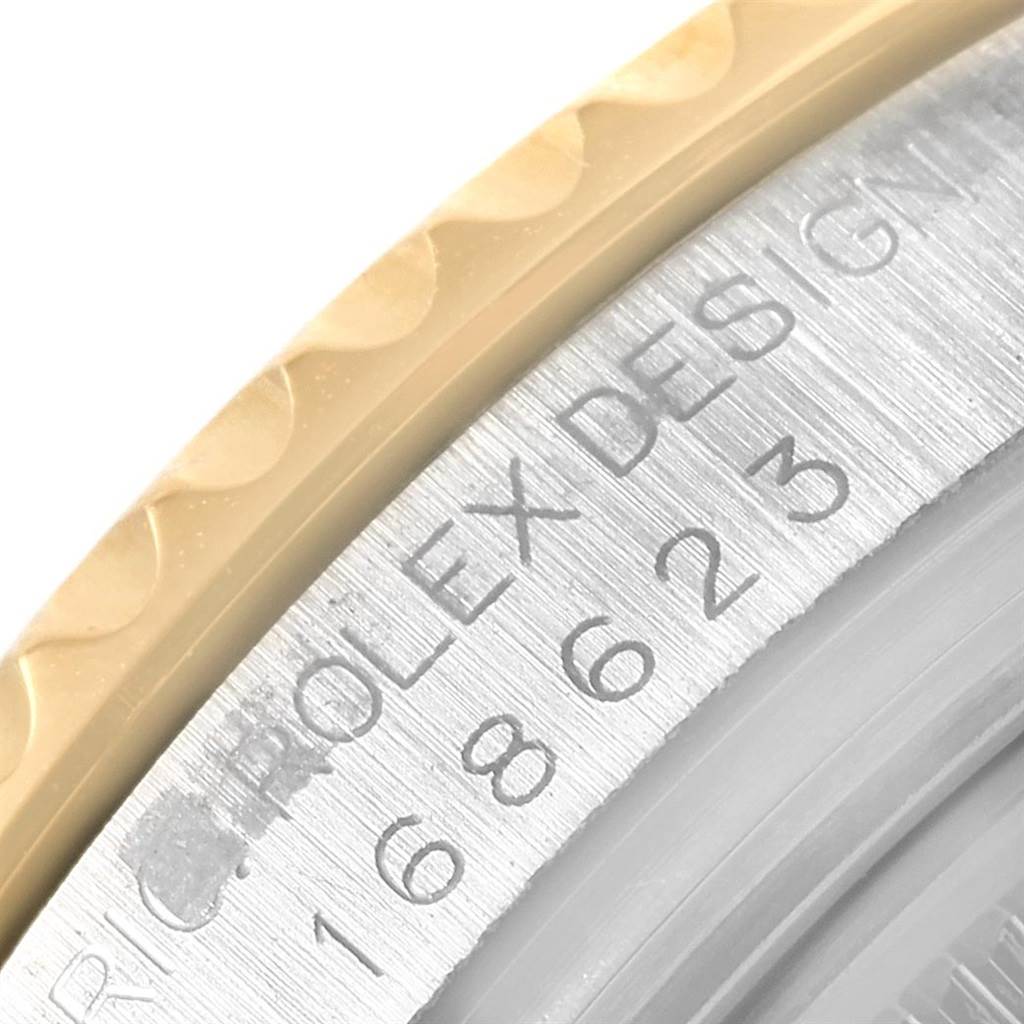 The image shows a close-up view of the caseback engraving and the edge of the bezel of a Rolex Yacht-Master 168623 Men's Steel and Gold (two tone) Grey Dial 168623 Men's Steel and Gold (two tone) Grey Dial watch.