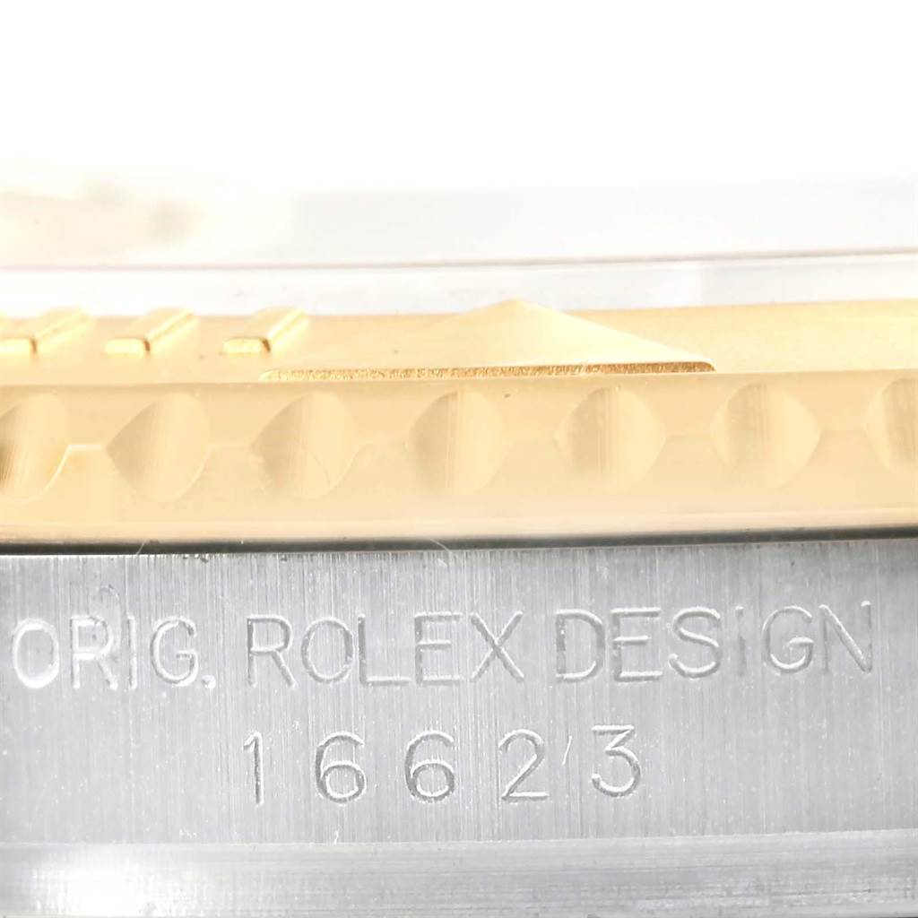 This close-up angle shows the model number and side view of the bezel on a Rolex Yacht-Master 16623 Men's Stainless Steel Champagne Dial 16623 Men's Stainless Steel Champagne Dial watch.