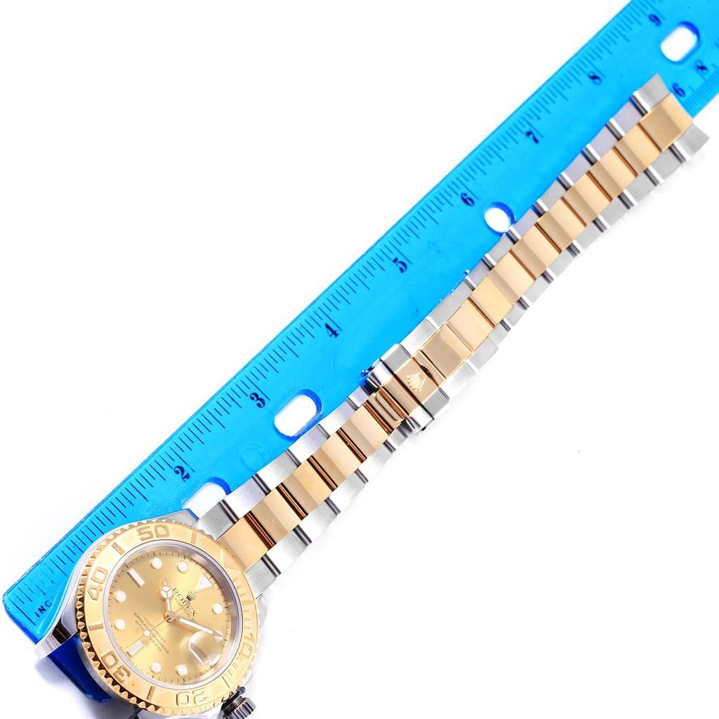 The image shows a Rolex Yacht-Master 16623 Men's Stainless Steel Champagne Dial 16623 Men's Stainless Steel Champagne Dial watch laid flat with a blue ruler measuring its bracelet length.