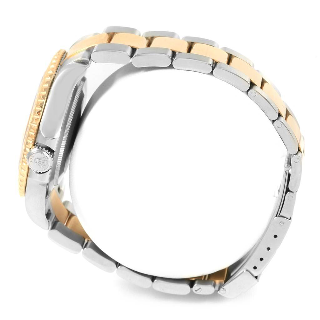 This side-angle view of the Rolex Yacht-Master 16623 Men's Stainless Steel Champagne Dial 16623 Men's Stainless Steel Champagne Dial watch shows the crown, case, and two-tone bracelet.