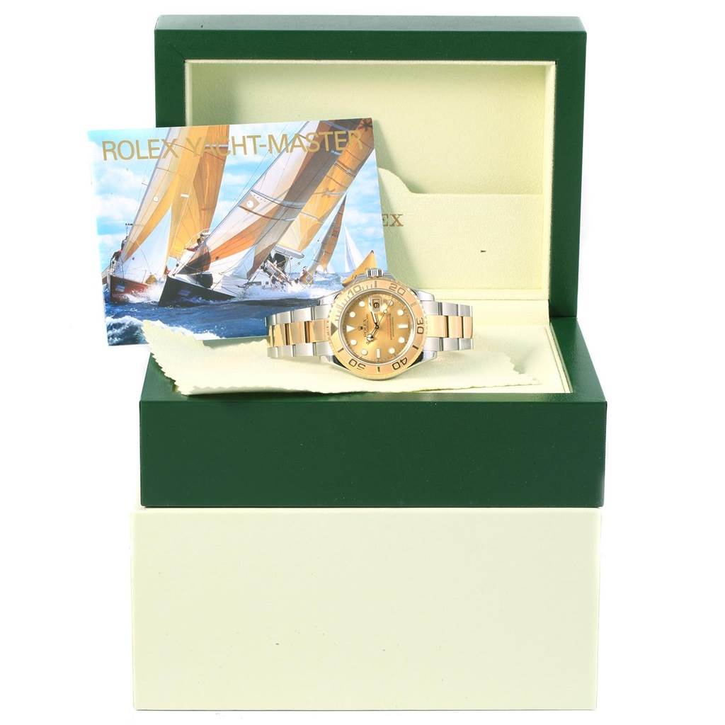 The Rolex Yacht-Master 16623 Men's Stainless Steel Champagne Dial 16623 Men's Stainless Steel Champagne Dial watch is displayed front-on in an open green box with a booklet behind it.
