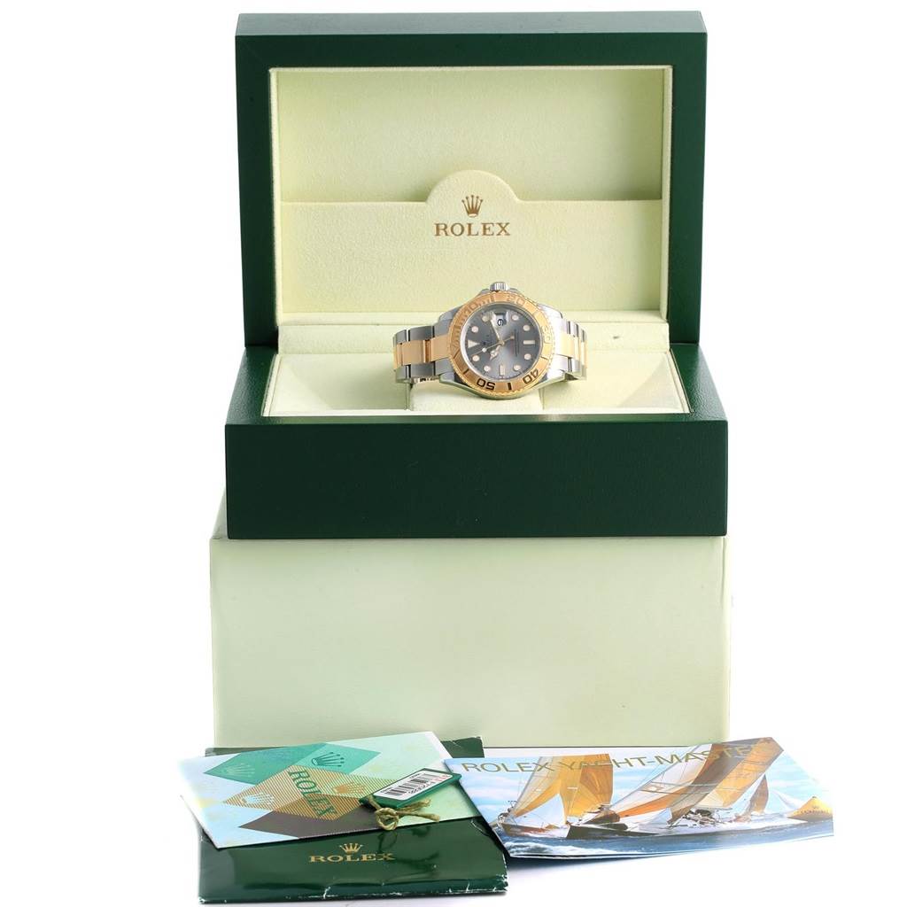 The Rolex Yacht-Master 16623 Men's Stainless Steel Grey Dial 16623 Men's Stainless Steel Grey Dial watch is showcased head-on in an open green box, with manuals and accessories placed nearby.