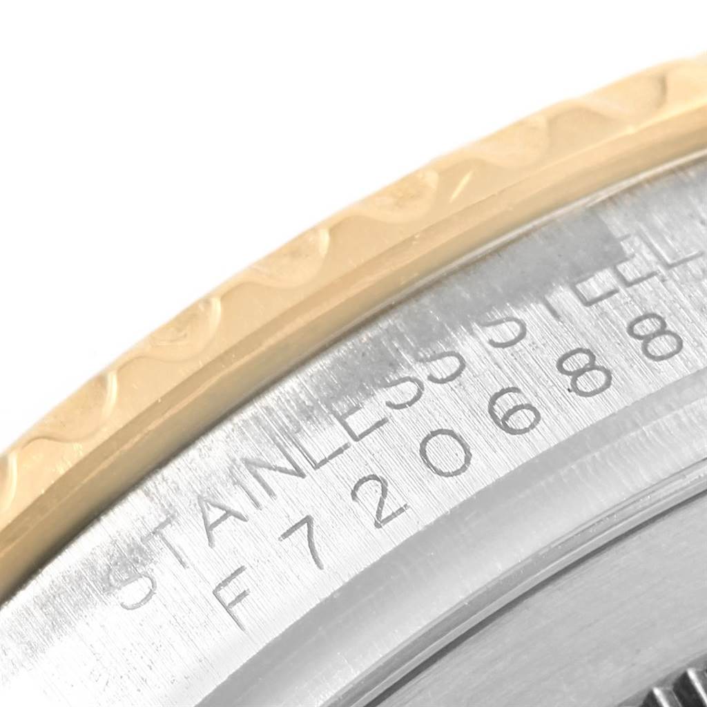 The image shows a close-up of the side of the bezel and case of the Rolex Yacht-Master 16623 Men's Stainless Steel Grey Dial 16623 Men's Stainless Steel Grey Dial watch, revealing part of the inscription.