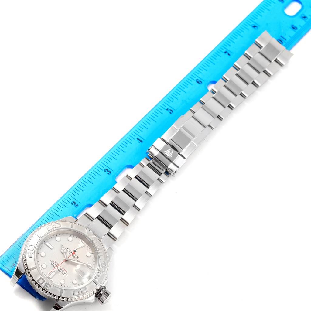 The image shows a Rolex Yacht-Master 16622 Men's Stainless Steel Silver Dial 16622 Men's Stainless Steel Silver Dial watch laid flat, displaying its face, bracelet, and clasp next to a blue ruler.