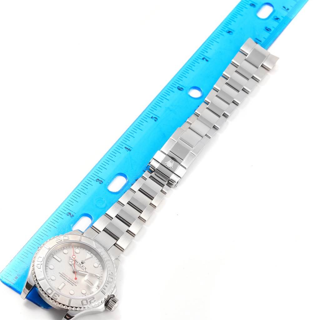 The image shows a Rolex Yacht-Master 16622 Men's Stainless Steel Silver Dial 16622 Men's Stainless Steel Silver Dial watch laid flat next to a blue ruler, displaying the face and bracelet.