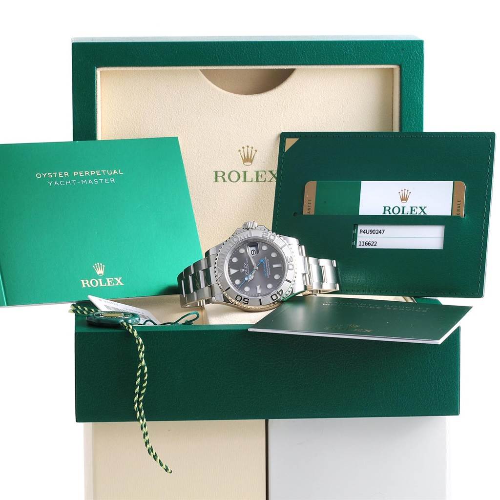 The Rolex Yacht-Master 116622 Stainless Steel Grey Dial 116622 Stainless Steel Grey Dial watch is shown front-facing with its accessories, including booklets and tags, laid out in a display box.