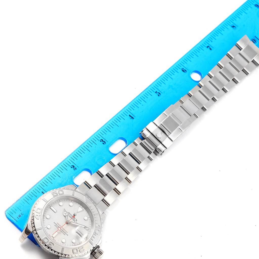 The image shows a Rolex Yacht-Master 16622 Men's Stainless Steel Silver Dial 16622 Men's Stainless Steel Silver Dial watch placed alongside a ruler, focusing on the bracelet, clasp, and partial watch face.