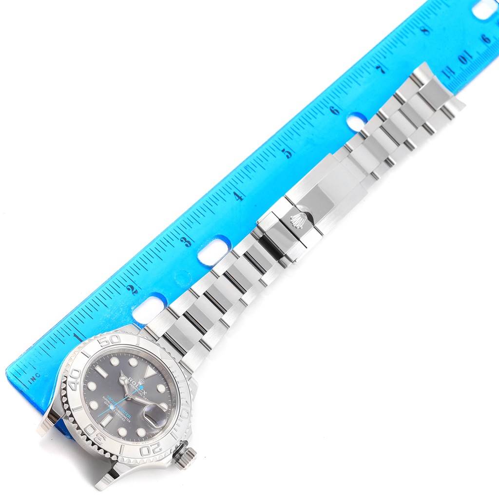 The image shows a Rolex Yacht-Master 116622 Men's Stainless Steel Grey Dial 116622 Men's Stainless Steel Grey Dial watch laid flat with its bracelet and clasp fully visible, next to a blue ruler for scale.
