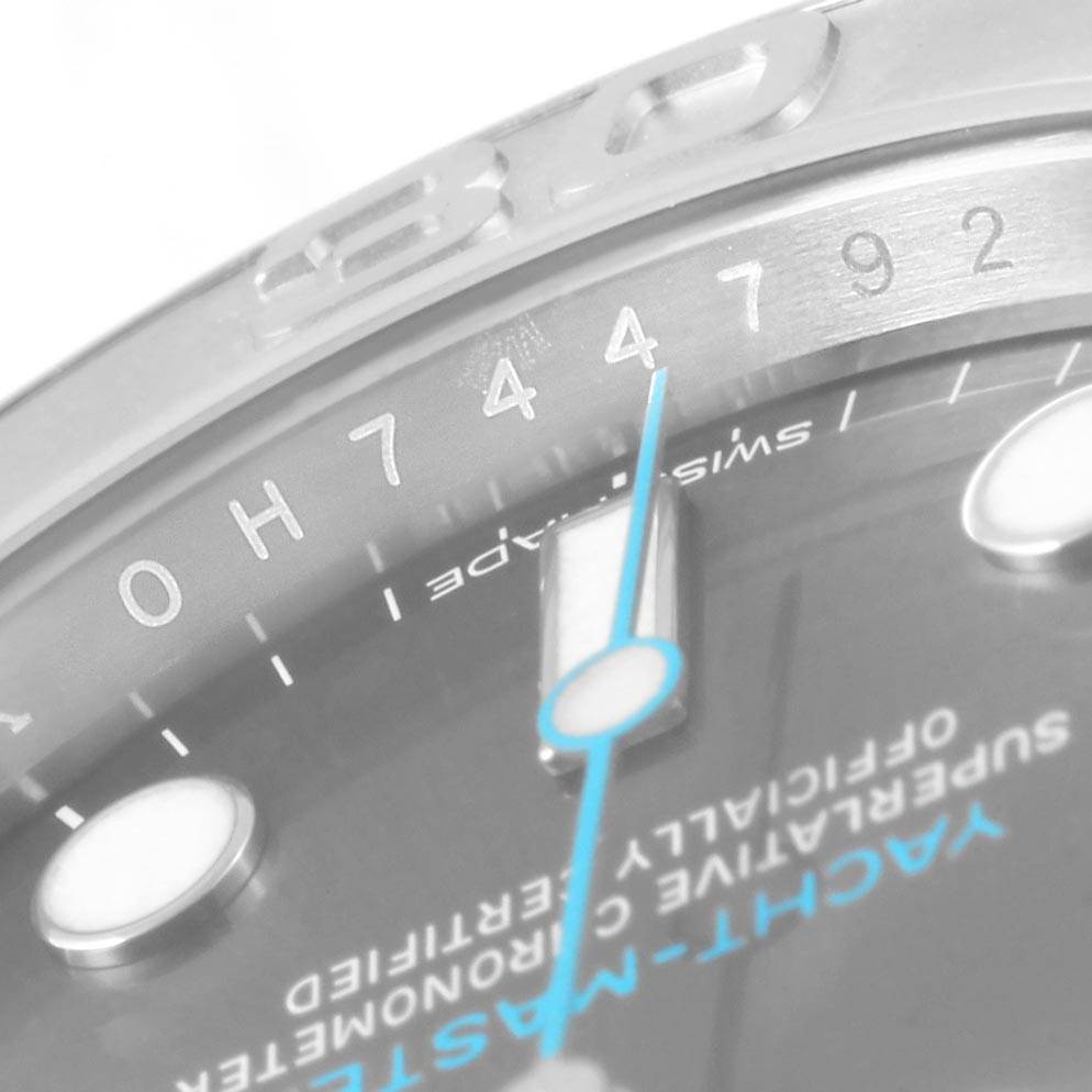 This close-up image of the Rolex Yacht-Master 116622 Men's Stainless Steel Grey Dial 116622 Men's Stainless Steel Grey Dial watch shows part of the bezel, dial, and minute hand.