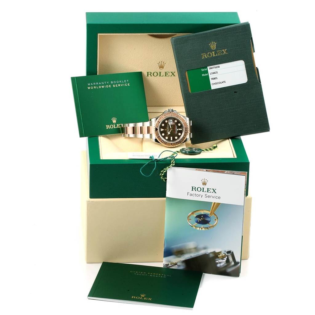 The Rolex Yacht-Master 116621 Men's Stainless Steel Brown Dial 116621 Men's Stainless Steel Brown Dial watch is displayed along with its box, warranty booklets, tags, and factory service manual.