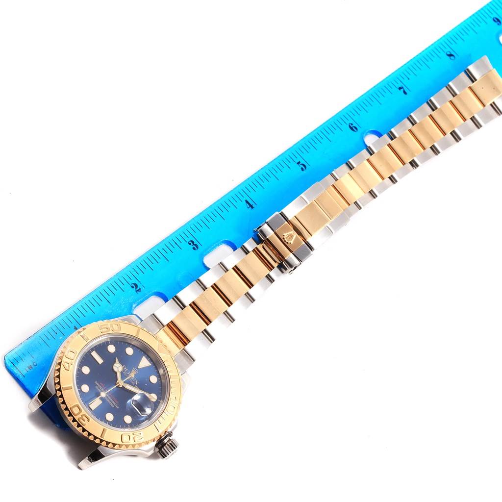 The Rolex Yacht-Master 16623 Men's Stainless Steel Blue Dial 16623 Men's Stainless Steel Blue Dial watch is shown from a top view, highlighting the face, bezel, and the full band with a ruler for scale.