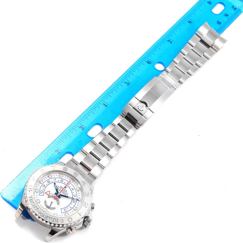 The Rolex Yacht-Master 116689 Men's White Gold White Dial 116689 Men's White Gold White Dial watch is shown from a top-down angle, fully extended next to a ruler.