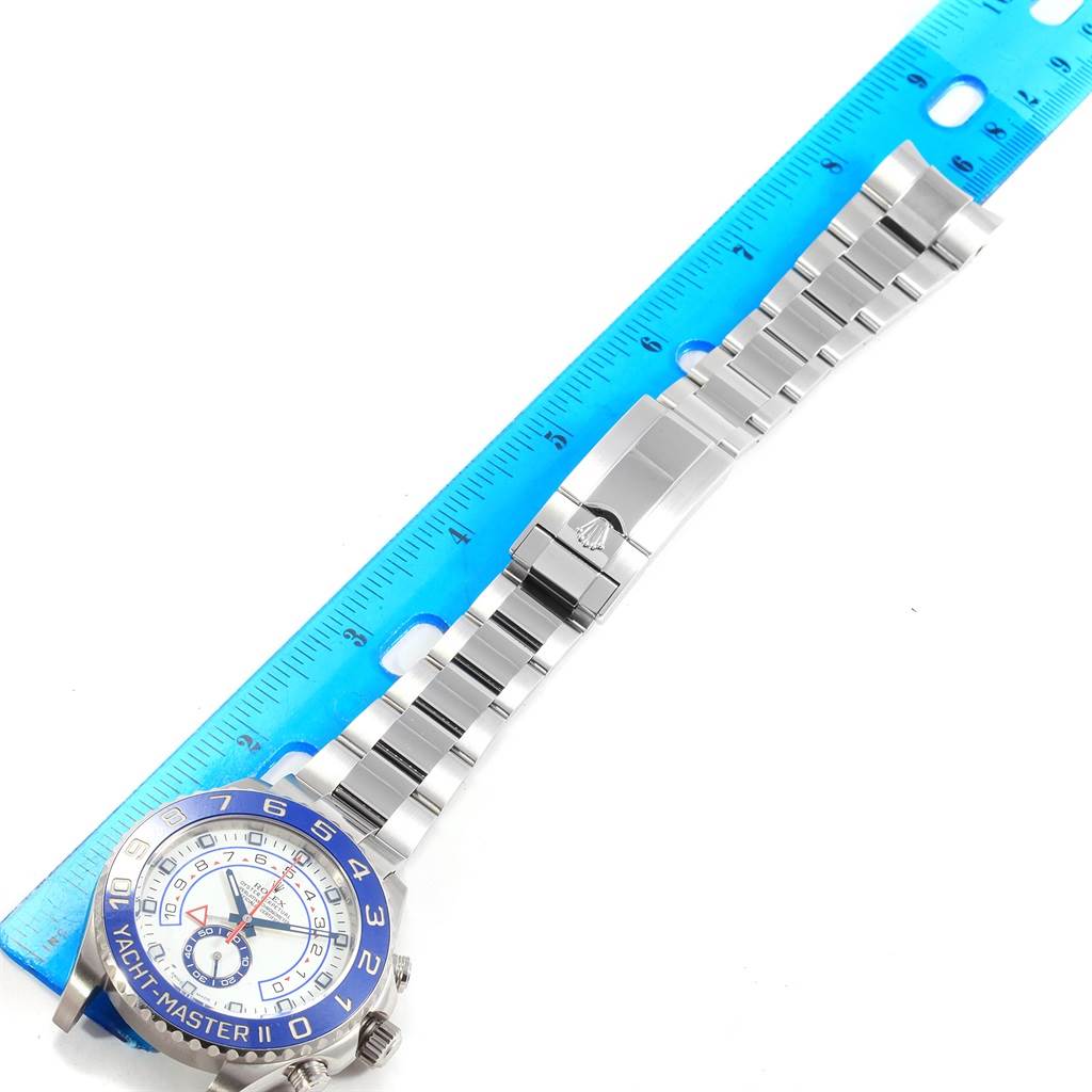 The image shows a Rolex Yacht-Master 116680 Men's Stainless Steel White Dial 116680 Men's Stainless Steel White Dial watch laid flat next to a ruler, displaying the face, strap, and clasp.