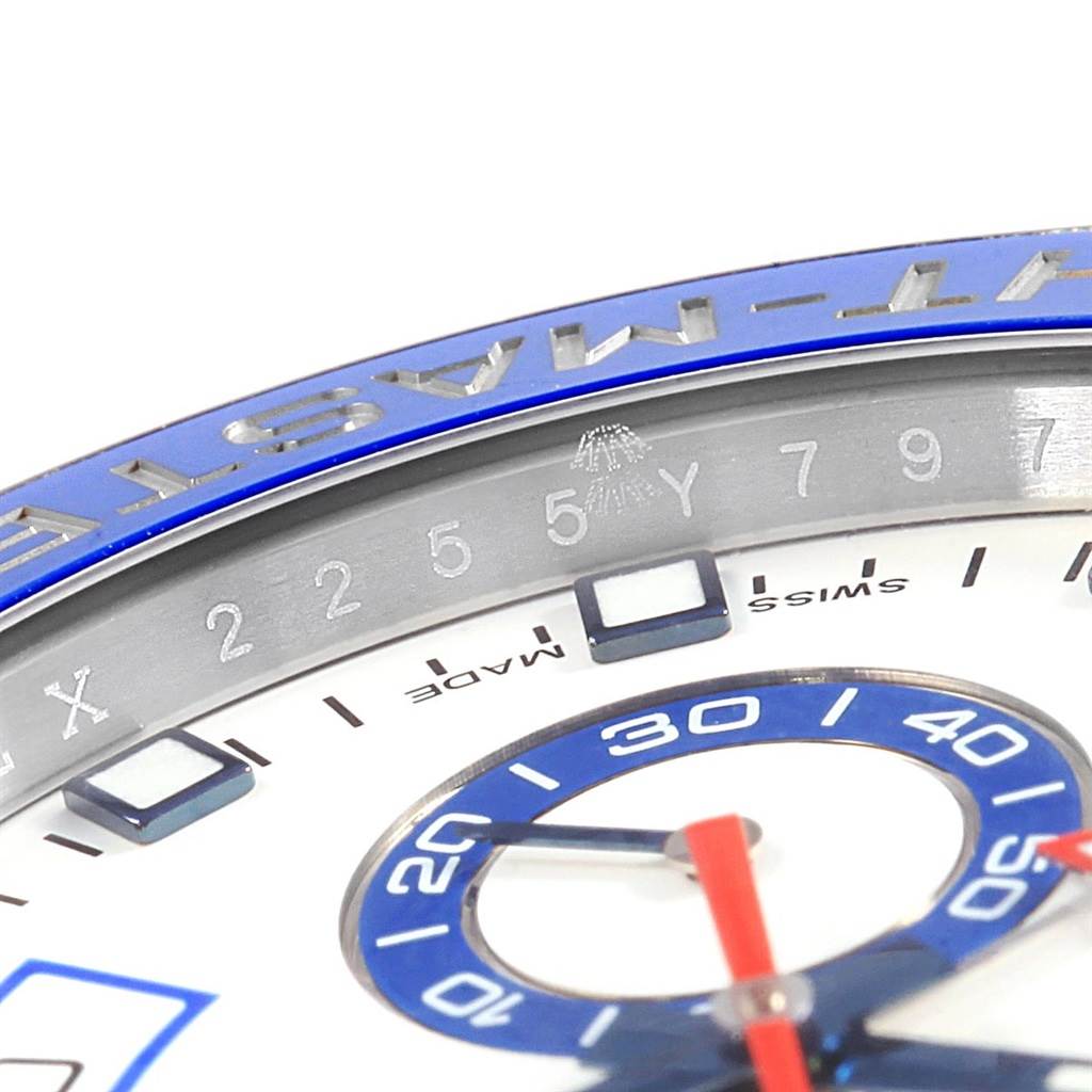The image shows a close-up of the dial and bezel of the Rolex Yacht-Master 116680 Men's Stainless Steel White Dial 116680 Men's Stainless Steel White Dial watch, highlighting parts of the hands and numeric markers.