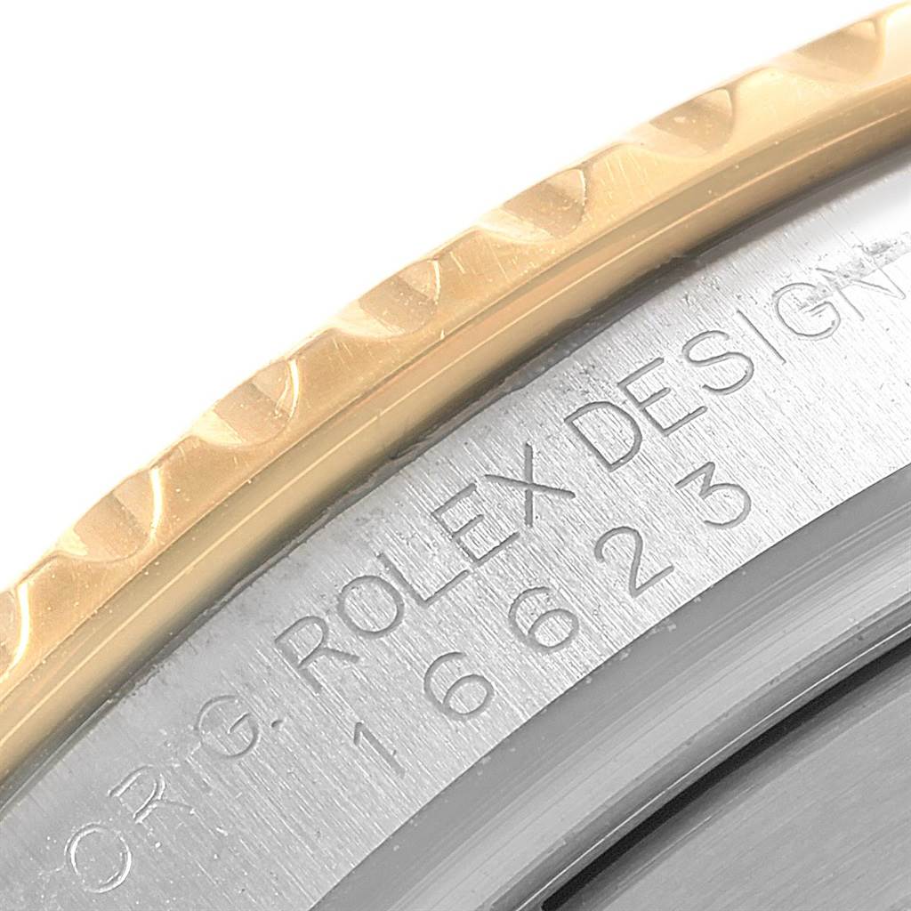 The image shows a close-up view of the Rolex Yacht-Master 16623 Men's Stainless Steel Mother of Pearl Dial 16623 Men's Stainless Steel Mother of Pearl Dial model's engraved serial number and part of the bezel.