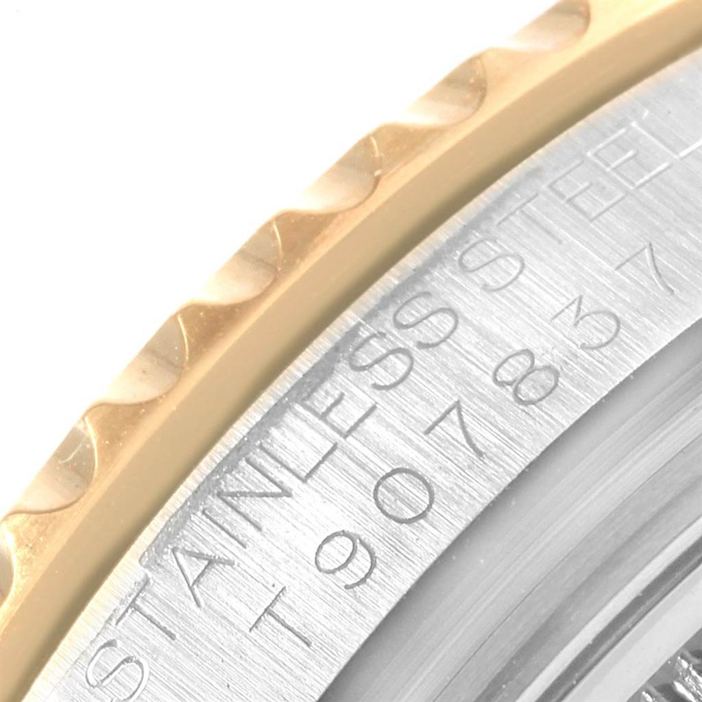 The image shows a close-up of the Rolex Yacht-Master 68623 Steel and Gold (two tone) White Dial 68623 Steel and Gold (two tone) White Dial's bezel and case, featuring the "STAINLESS STEEL" engraving.